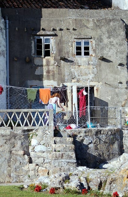 a guarda, galicia, casa vieja, old house, clothes hanging, hang up the clothes, facade, rustic, ancient, old, stone, architecture, home, stone wall, pity, houses, old construction, antiques, stone house, woman, casa.