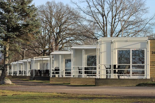 A row of modern holiday cottages in a tranquil forest setting, perfect for a peaceful retreat. Modular Homes.