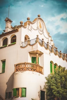 Artistic view of Casa Trias with green shutters and balcony in Barcelona. Casa Verde Amarela.