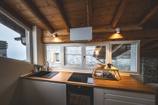 A stylish modern kitchen with wooden beams and natural light in Calozzo, Italy. Kitchen Decor, Decoração da Cozinha.