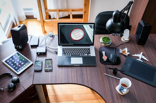 A contemporary office desk setup with laptops, gadgets, and accessories, creating a tech-savvy workplace. Technology, Tenologia