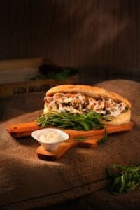 Delicious chicken sandwich with mayonnaise and greens served on a wooden board. Food, comida