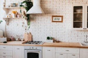 Stylish kitchen interior with modern appliances, wooden counters, and greenery accents. Kitchen, Cozinha.