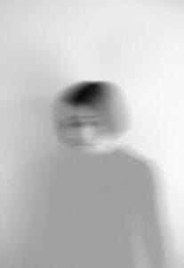 Artistic blurred grayscale portrait capturing motion and emotion. Anxiety, Ansiedade.