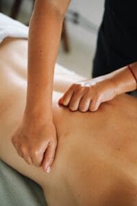 Close-up of a relaxing therapeutic massage focusing on back muscles in a tranquil spa environment. Tantric Massage, Massagem Tântrica.