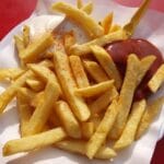 Delicious crispy French fries served with ketchup and mayonnaise on a paper plate, Fast food, food, comida.