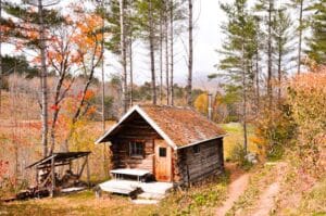 Charming rustic cabin surrounded by fall foliage and towering trees. Wooden House, Casa de Madeira.