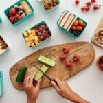 Overhead view of fresh fruit and vegetables being prepared for a healthy lunch. lunch box, food, comida.