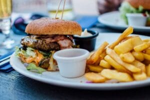 Close-up of a juicy burger and crispy fries served with sauces, perfect for a hearty meal. Food, comida, Fast food.